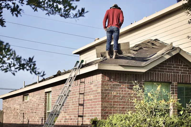 Professional roofer working on a residential roof in Brecknock